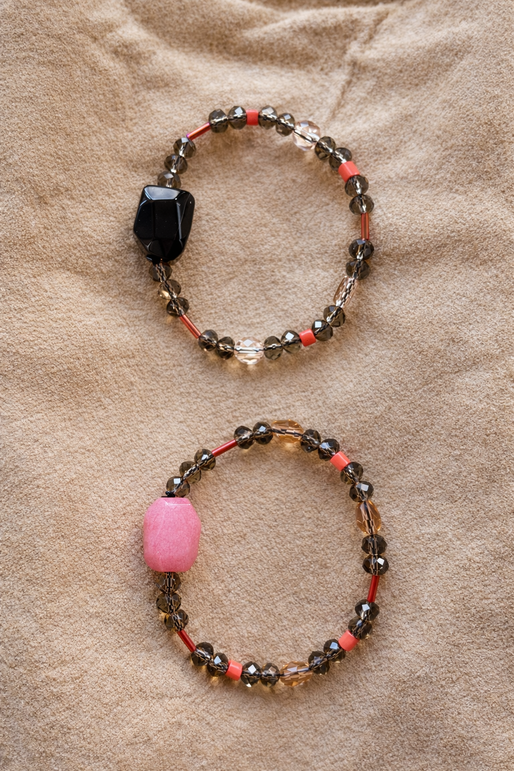 Anther House Two beaded bracelets with colored beads on a beige fabric background Made in Philly