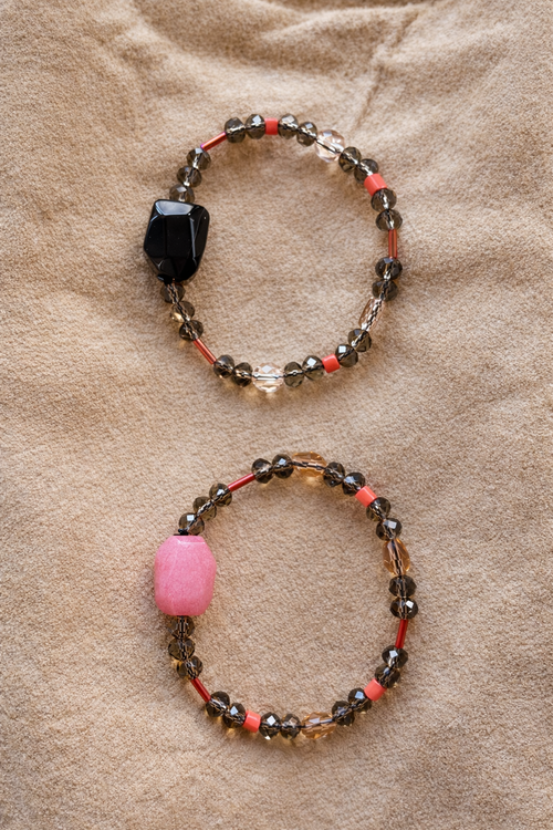 Anther House Two beaded bracelets with colored beads on a beige fabric background Made in Philly