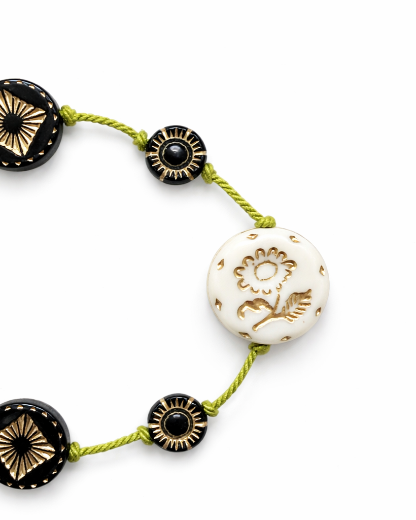 Anther House Necklace with black, gold, and white beads on a white background Handmade in Philadelphia