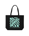Black tote bag with teal leaf design and text 'All You Need Is Plants' on a white background