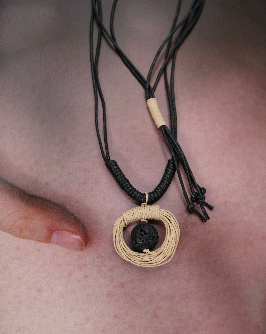 Handwoven Cord & Lava Stone Necklace with black adjustable cord, natural fiber pendant, and artisan wrapped details