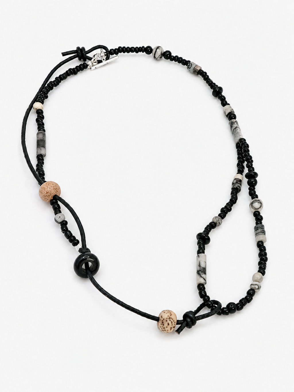 Black Stone & Cord Beaded Necklace featuring handmade layered design, textured beads, and knotted cord details