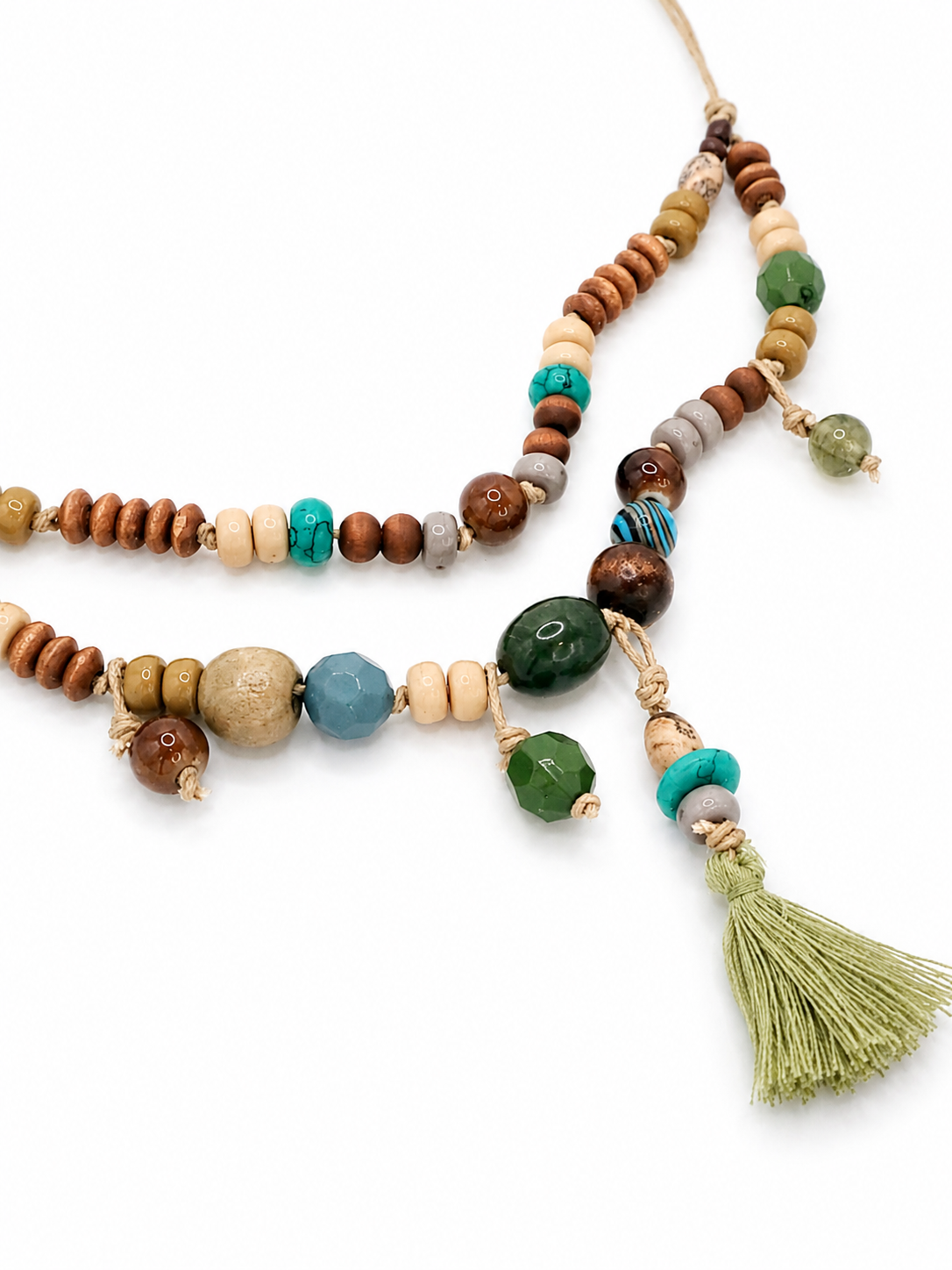 Handcrafted mixed bead tassel necklace with earthy tones, natural textures, and artisan cord construction