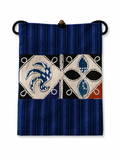 Indigo dyed artisan textile pouch featuring Chinese heritage inspired patterns, woven details, and vintage style closure